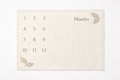 Naya Baby knitted monthly milestone blanket 1-12 months cream oat white linen flat lay