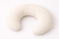 Naya Baby organic cotton nursing and feeding pillow C-shaped oat cream white linen flat lay